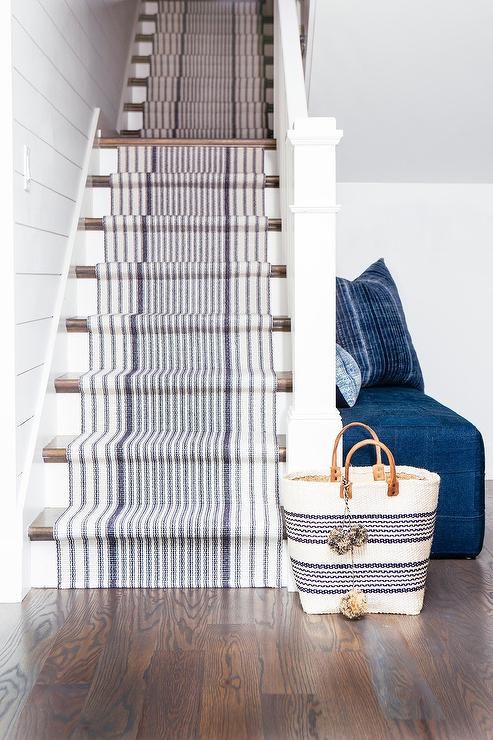a white staircase made nautical with just some striped nautical carpet covering it is a cool idea