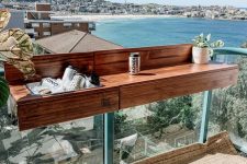 a wooden balcony bar table hanging on the railing is a lovely idea for a modern tiny outdoor space, it provides you with storage space