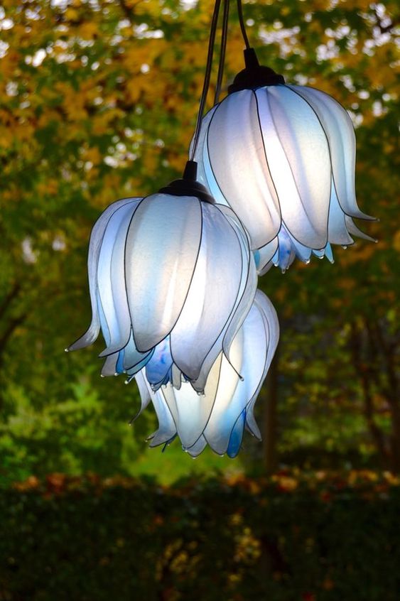 An arrangement of blue flower shaped suspended lamps is a bold and cool idea for decor