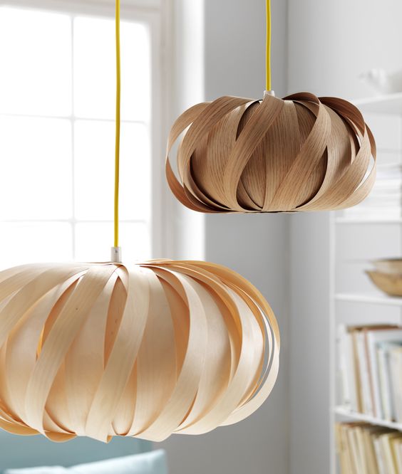 pretty plywood pendant lamps in blush and brown resemble flowers and add a beautiful and soft touch to the space