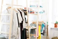 several tall ladders with shelves to create a comfy wardrobe for all kinds of clothes and accessories