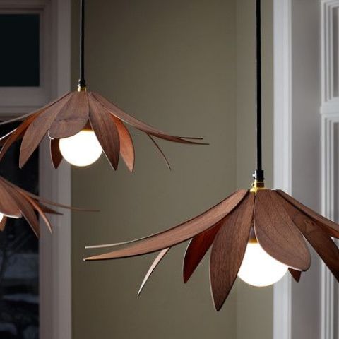 veneer lotus pendant lamps in a rich tone of wood are a chic addition to a modern interior