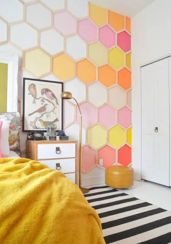 a bold bedroom done with a colorful honeycomb accent wall is a bright and cool idea to rock, it will add both color and pattern