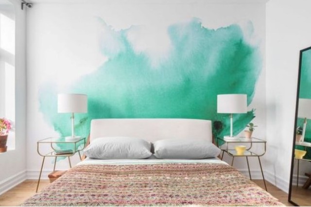 a bold green watercolor wall makes the bedroom colorful and vivacious