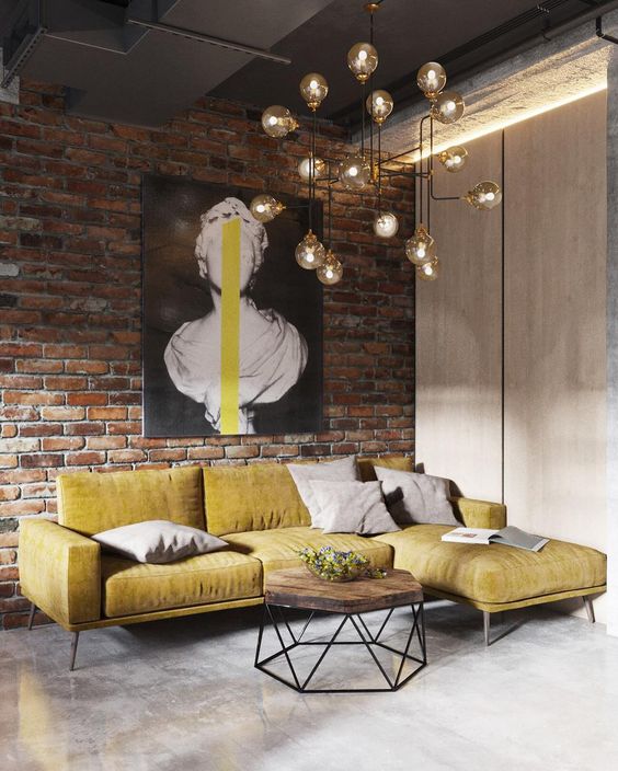 a brick wall, a metal ceiling, a concrete floor makes up a cool base for an industrial living room, and a bulb chandelier adds to it