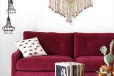 a chic modern burgundy sofa with refined legs for creating a fall mood in the living room