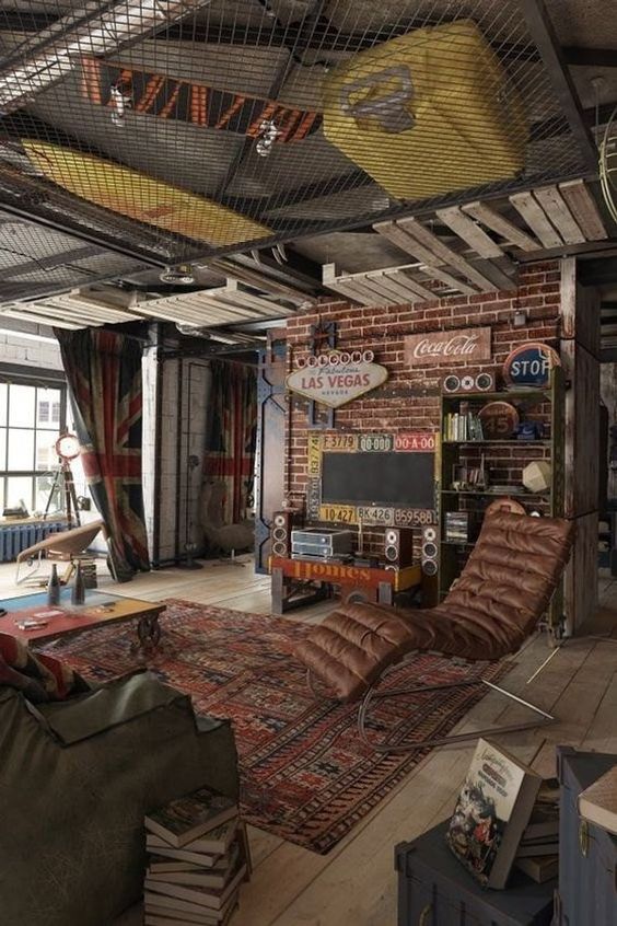 a colorful industrial living room with brick walls, leather furniture, a net ceiling with storage