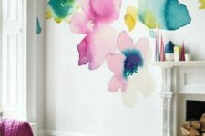 an accent wall with bright watercolor blooms all over instead of a usual artwork, it’s a bold and catchy solution