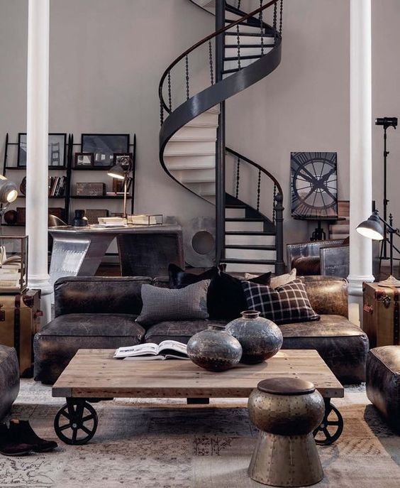an industrial living space with metal furniture and accessories, leather furniture, a table on wheels