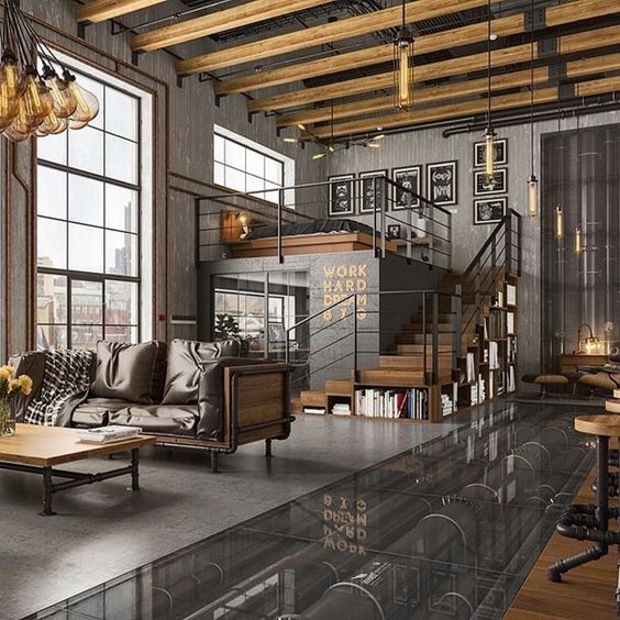 an industrial open layout with wood and piping furniture, pendant lamps, a ceiling with beams and much metal in decor