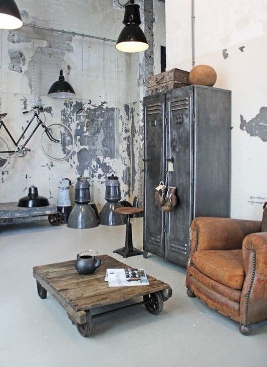 shabby chic walls, a vintage metal storage unit, leather furniture, retro metal lamps and a table on casters