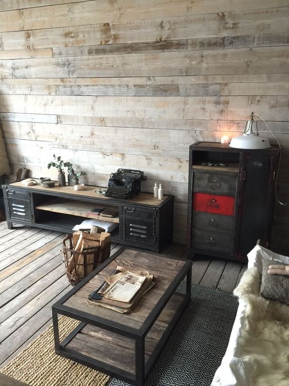 weathered wood floor and walls, an industrial wood and metal coffee table, vintage metal furniture