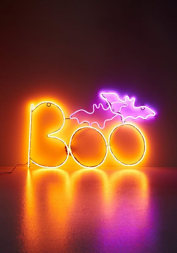 a bold neon pink and yellow sign for Halloween decor is an amazing and very fresh idea to rock