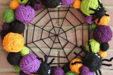 a vibrant halloween wreath with yarn balls