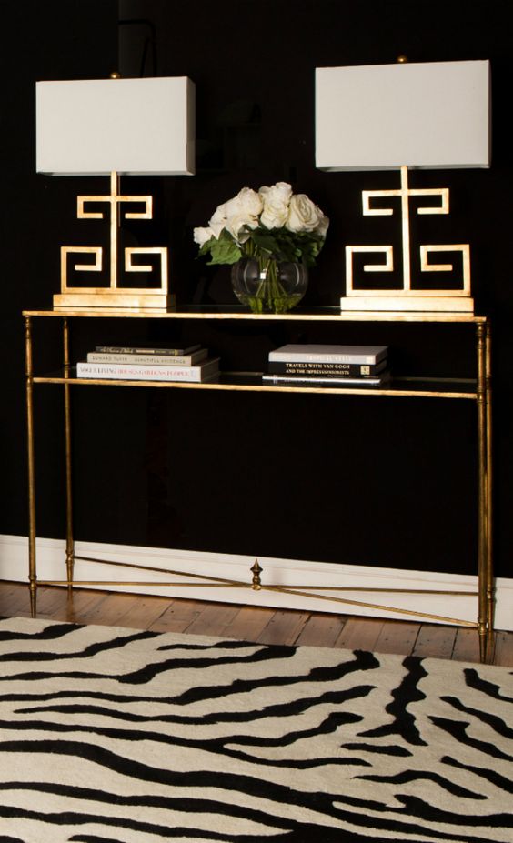 a gold console table with a shelf, matching gold table lamps will give a strong glam feel to the room
