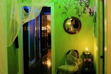 a neon green Halloween space styled with spiderwebs and ghosts,s lights and vintage furniture is pure chic