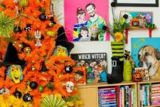 a neon orange and yellow Halloween tree decorated with black, green ornaments, monster masks and skulls is fun