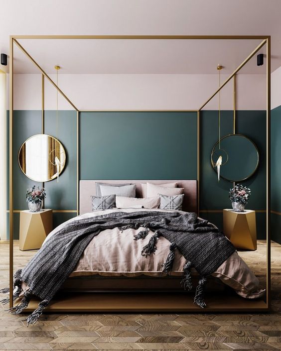 a statement glam bedroom with a parquet floor, a gold canopy bed, gold faceted nightstands and mirrors in gold frames