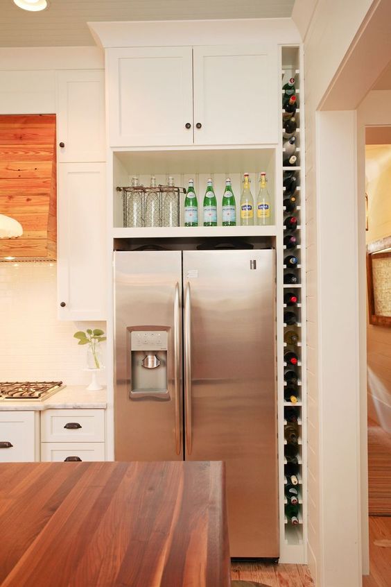 a vertical wine shelf built in between the wall and the fridge will save your space