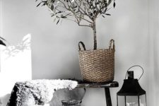 baskets, candles, a faux fur piece add a natural feel to the Nordic space and keep the monochromy up