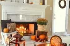 bright fall leaf arrangements, orange pumpkins and fall blooms bring a strong fall feel to the space