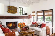 fall-colored textiles and a bright fall bloom arrangement in a basket make this lviign room more fall-like