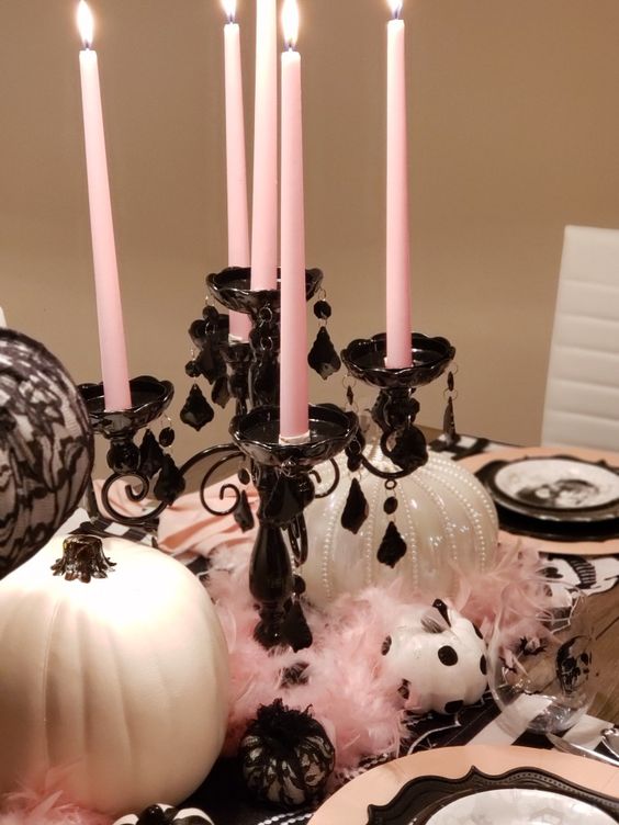glam Halloween styling with white pumpkins, a black candelabra with pink candles and lace