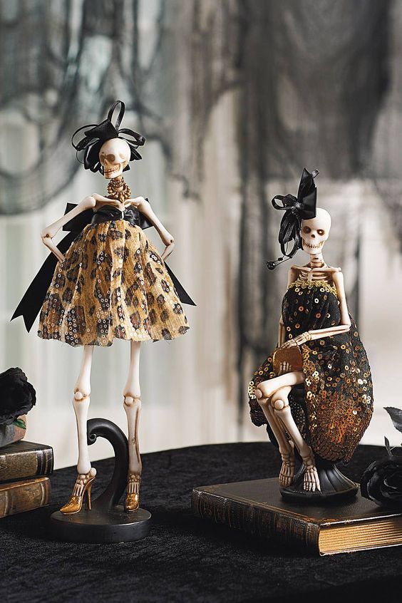 glam ghoulish decor - skeleton in designer dresses and with large bows - is great for Halloween