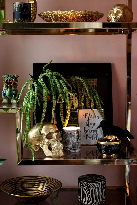 refined and glam Halloween styling with an artwork, a crow, black skulls and some candles