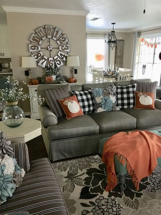 rust-colored textiles and plaid pillows make this farmhouse living room very fall-like