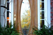 a Halloween front door styled with a branch and blackbirds is a stylish idea that doesn’t require much effort
