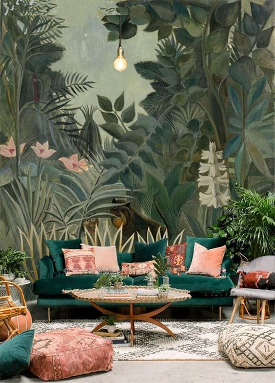 a bold living room with a tropical all mural that sets the tone and matches the emerald sofa with pink pillows