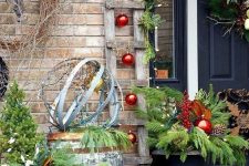 a ladder, a barrel, a galvanized bathtub with firewood, vine wreaths, pinecones and fir branches for cozy rustic decor