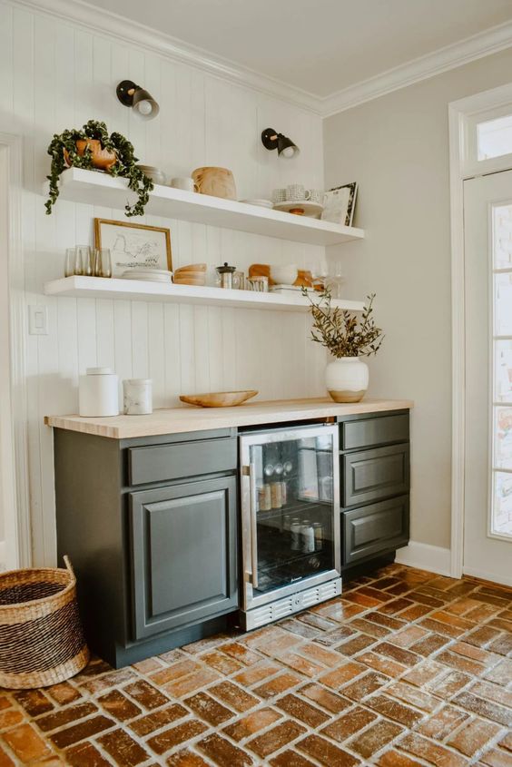 A mid century modern with open shelves, black cabinetry, potted greenery and various decor and a wine cooler is a lovely idea for a farmhouse space