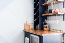 a navy home bar with stained open shelves, a wine cooler and some cabinetry with open storage and not only is a lovely idea for a farmhouse space