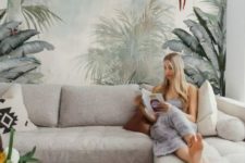 a neutral living room made catchy and bold with a large tropical wall mural that makes the space adventurous