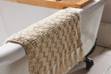 a neutral woven crochet rug with tassels will be a great addition to your bathroom and will add it a spa feel easily