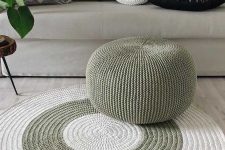 a pretty white and green crocheted rug and a matching green pouf will add chic and interest to your modern or Scandi space
