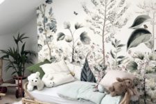a romantic kid’s space with a beautiful botanical wall mural and potted plants that match it