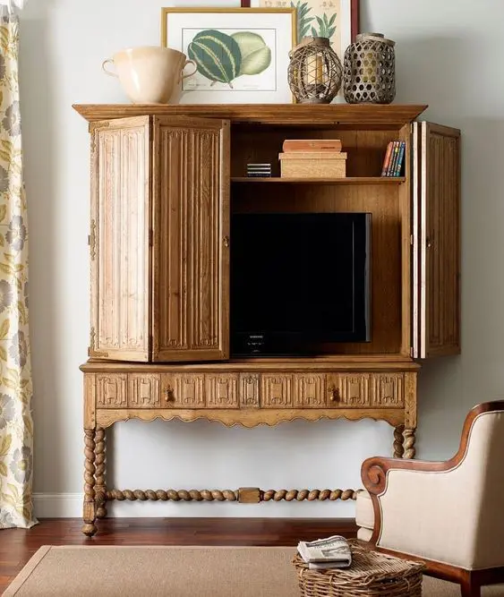a sophisticated vintage storage unit with a TV inside is a cool solution for a vintage interior, it looks very chic and cool