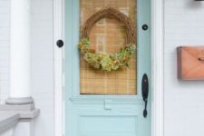 a vine wreath with blooms and greenery, heirloom pumpkins and fall blooms in baskets for a Thanksgiving feel