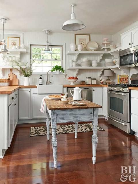 a welcoming cottage kitchen with shaker cabinets, butcherblock countertops, a beadboard backsplash, pendant lamps and a shabby chic table
