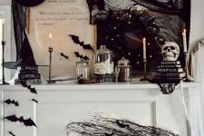 a white piano decorated with black branches and bats, lights, black spider web, hats, bats, candles and other stuff looks amazing