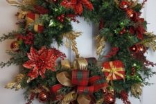 a beautiful Christmas wreath of evergreens, with poinsettia, gift boxes and ribbon bows plus ornaments