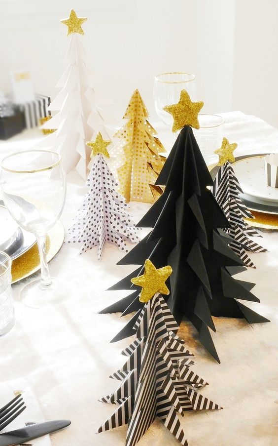 a black and white Christmas trees and gold ones with various patterns and gold glitter star toppers for holiday decor
