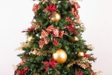 a bold red and gold Christmas tree with bows, gilded foliage, large gold ornaments