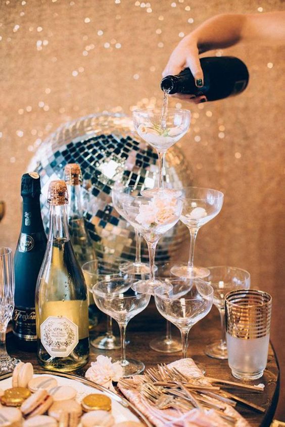 a champagne tower is a classic thing for NYE parties, it can be rocked anytime, and disco balls are great for decor