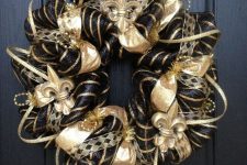 a glam vintage Christmas wreath in black and gold, with ribbons and beads is amazingly lovely