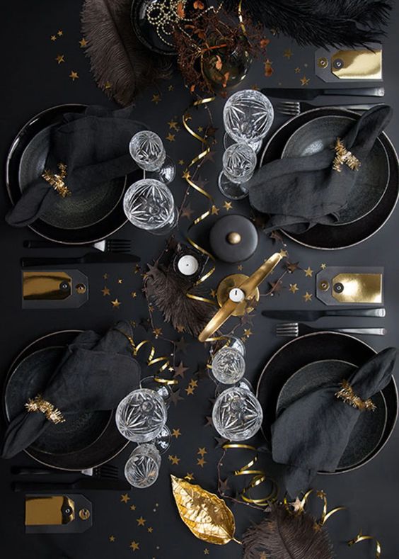 a lovely Christmas tablescape with black plates and chargers, black linens and gold touches for ultimate elegance