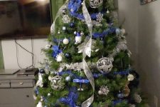 a lovely Christmas tree with blue and silver decor – ribbons, ornaments, snowflakes and stars is an amazing idea